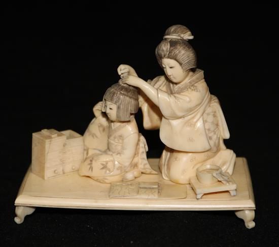 A Japanese figural ivory okimono, width 10cm